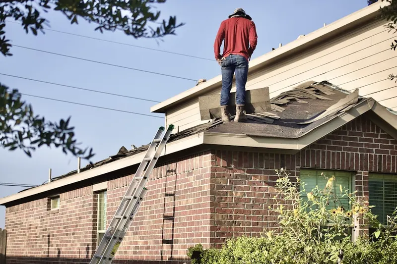 Professional roofer working on a residential roof in Kearny